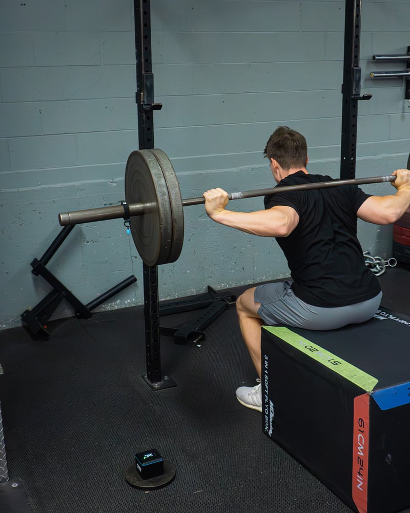 Athlete lifting safely at submaximal load while OVR Velocity tracks bar speed