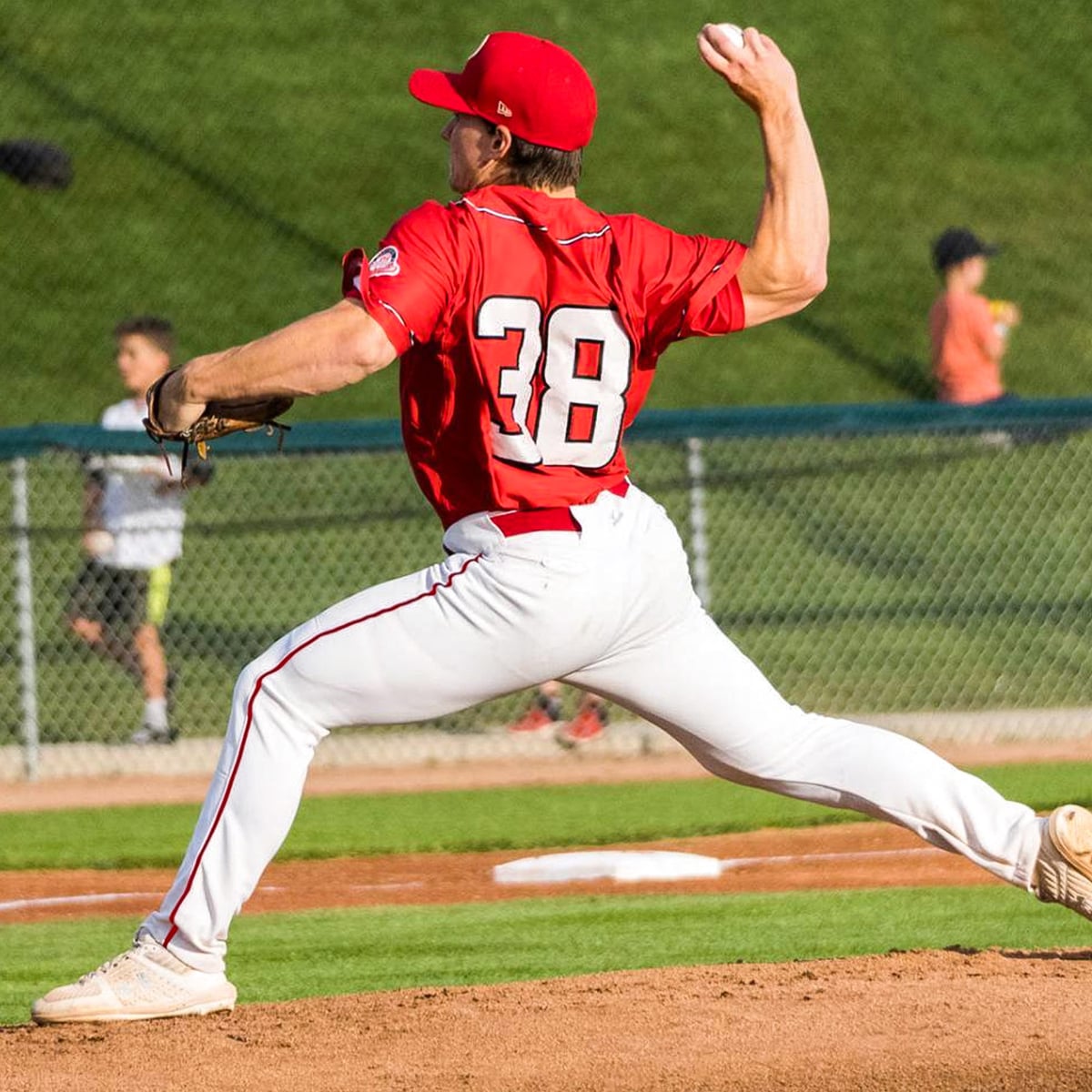Adam pitching off the mound during his playing days