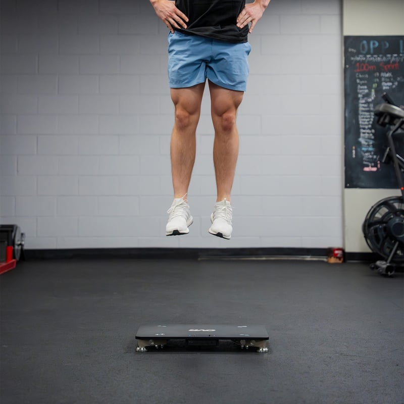 Athlete jumping above the OVR Force plate in a gym