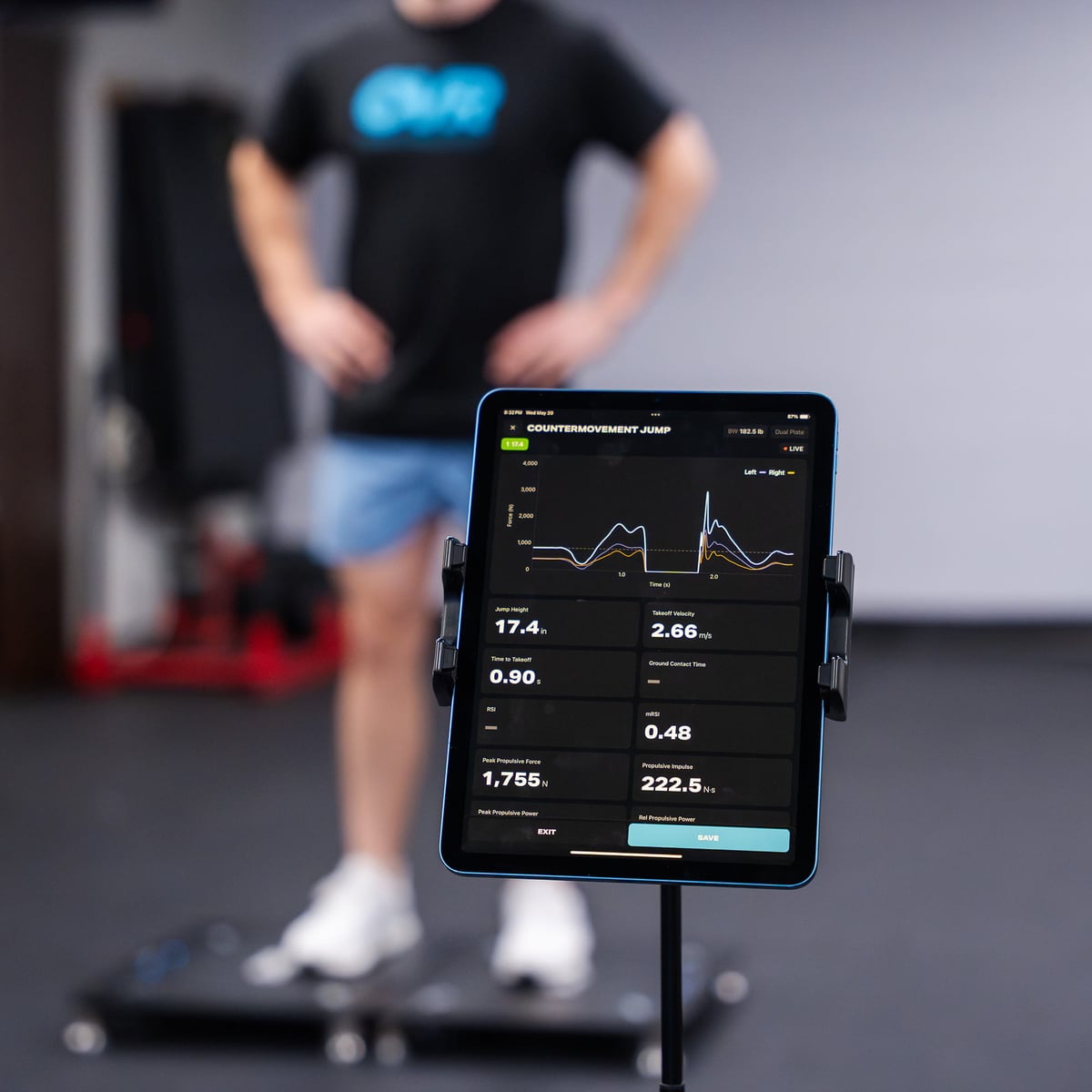 Athlete standing on two OVR Force plates, countermovement jump results on a tablet in the foreground
