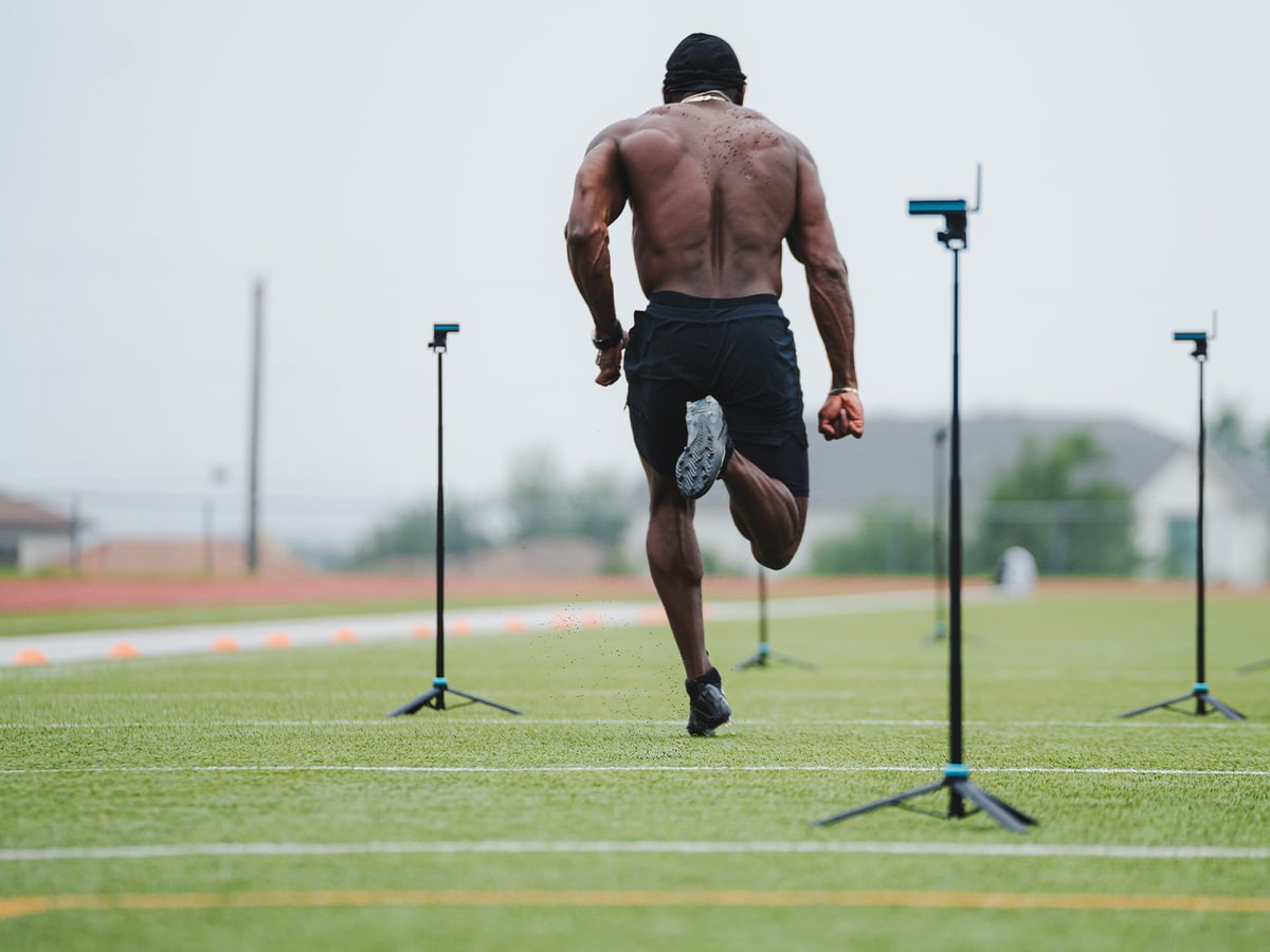 College athletes being timed on a speed drill.