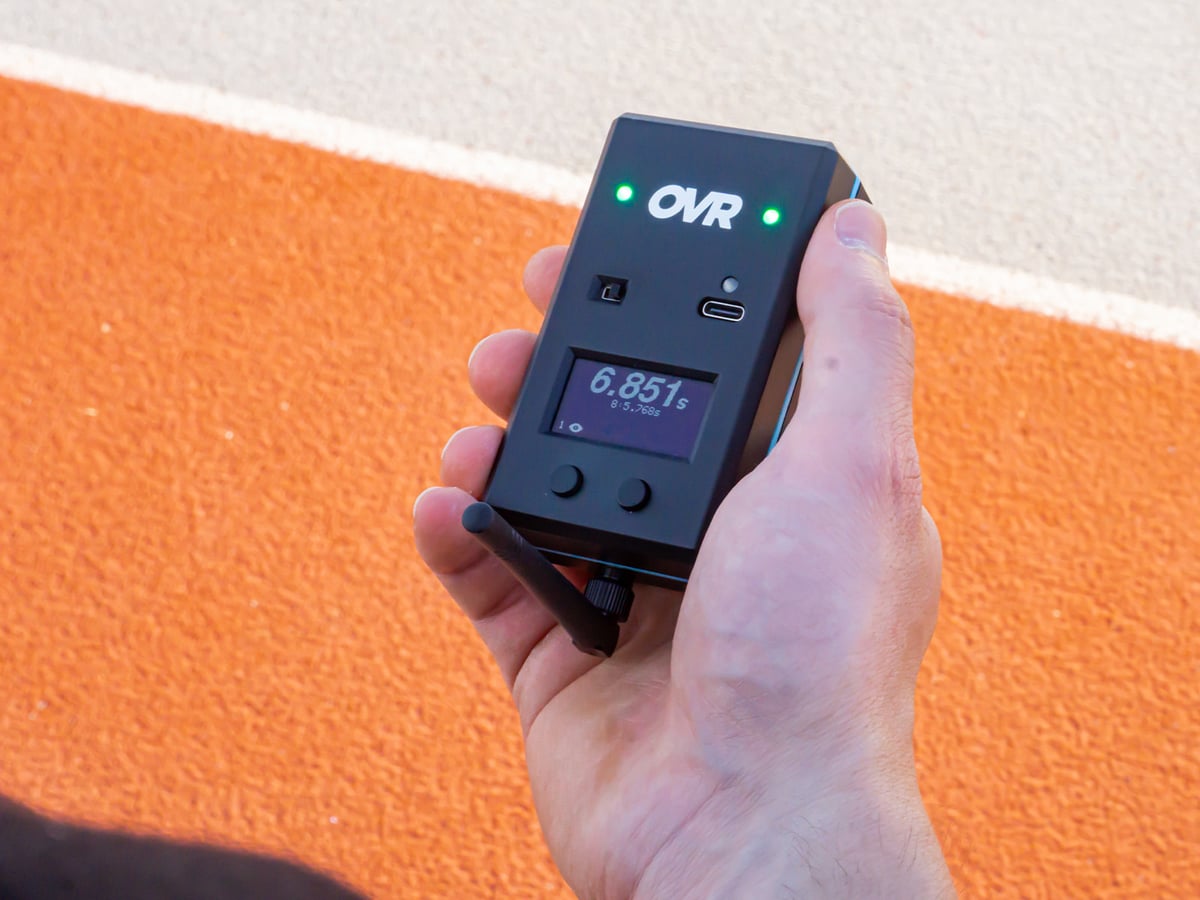 Private coach timing a client at a turf facility.