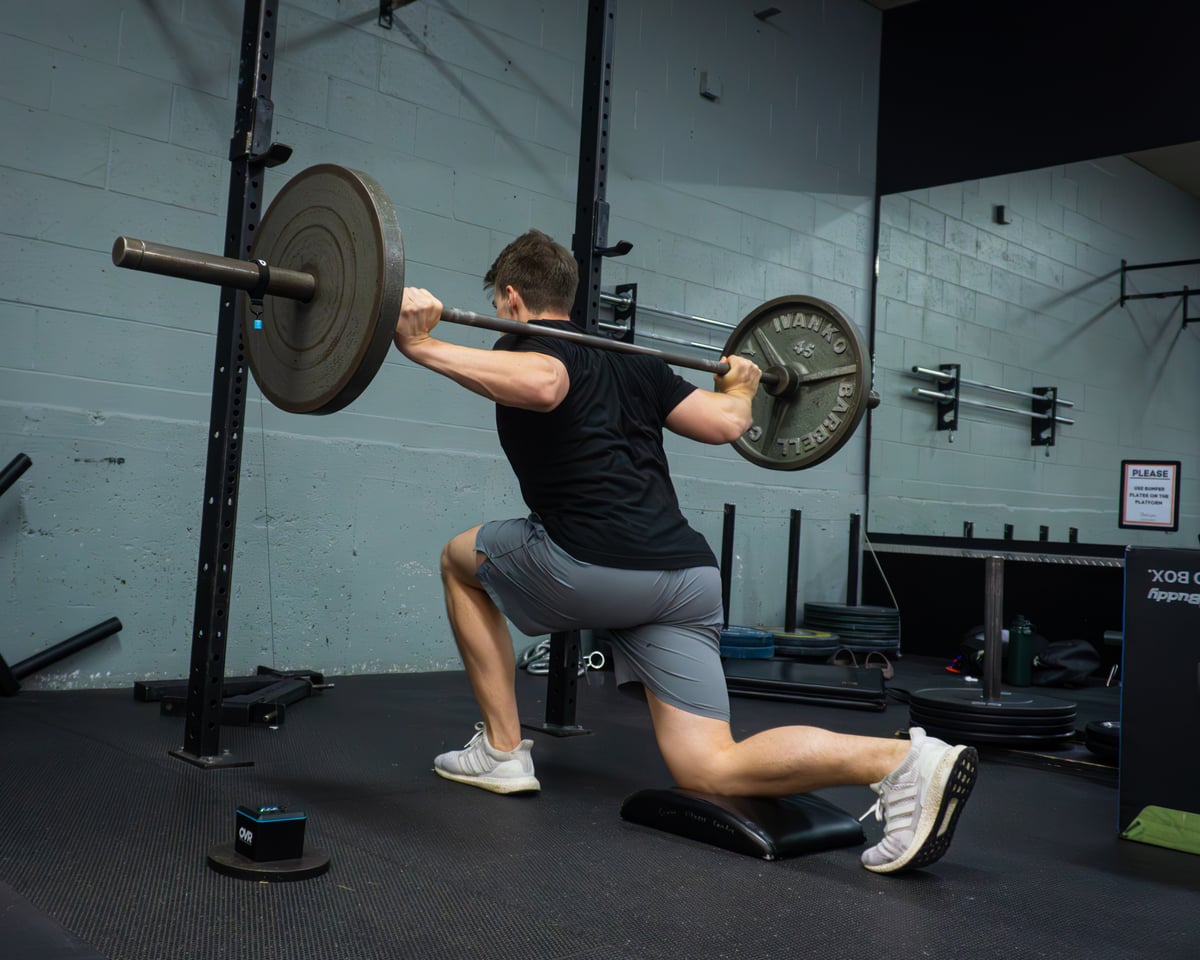 Athlete in rehab setting performing a controlled lift.