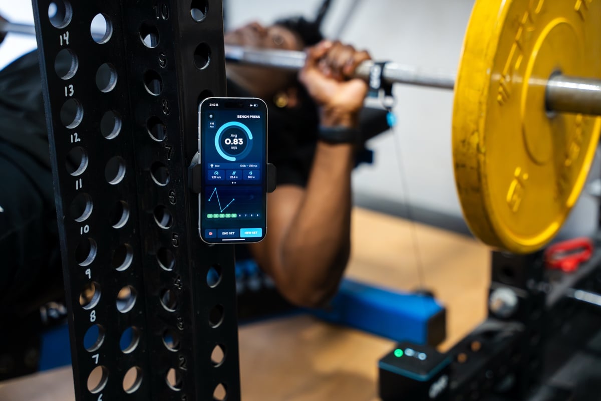 Private coach working with a client on a bench press.